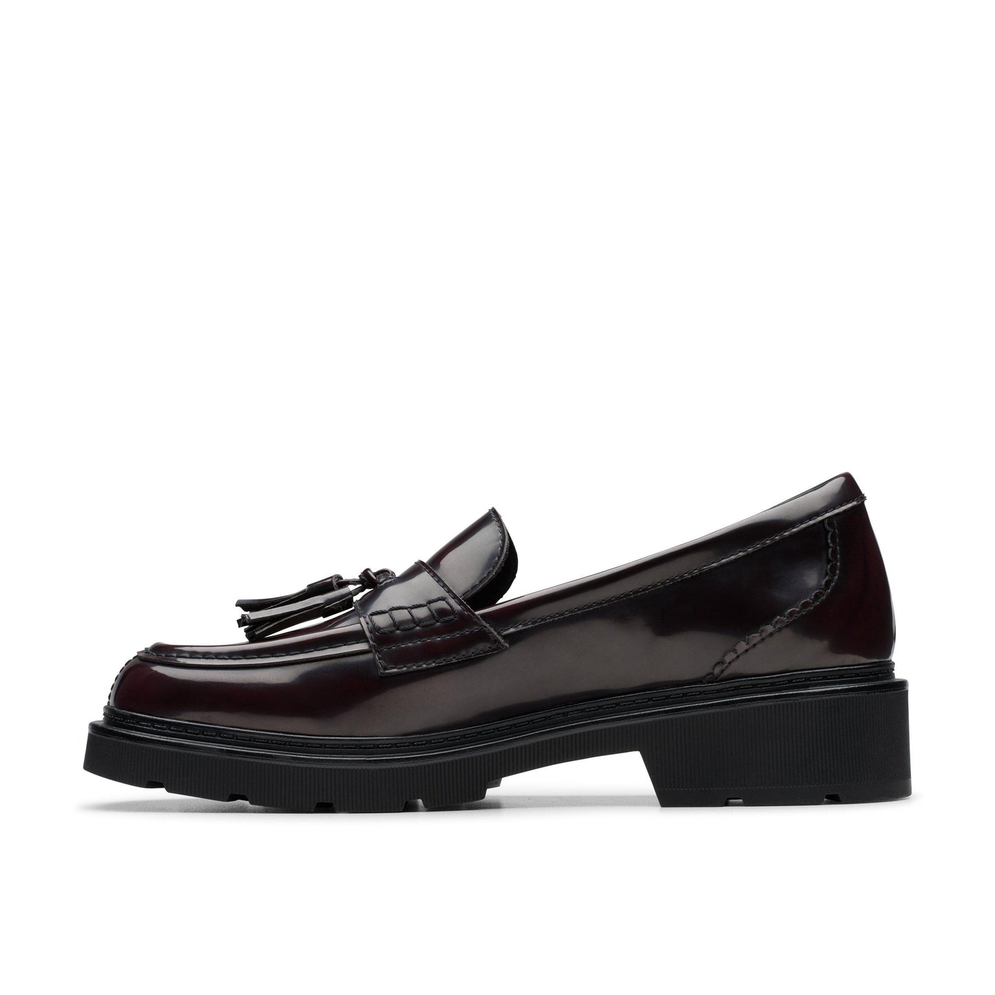Side view of a dark red leather loafer with a black sole and tassels.