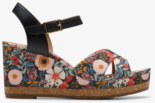 Wedge sandal with floral print and black ankle strap with gold buckle.