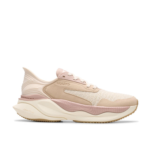 Tan colored athletic shoe with a thick beige and pink sole and the word "CLARKS" on the side.