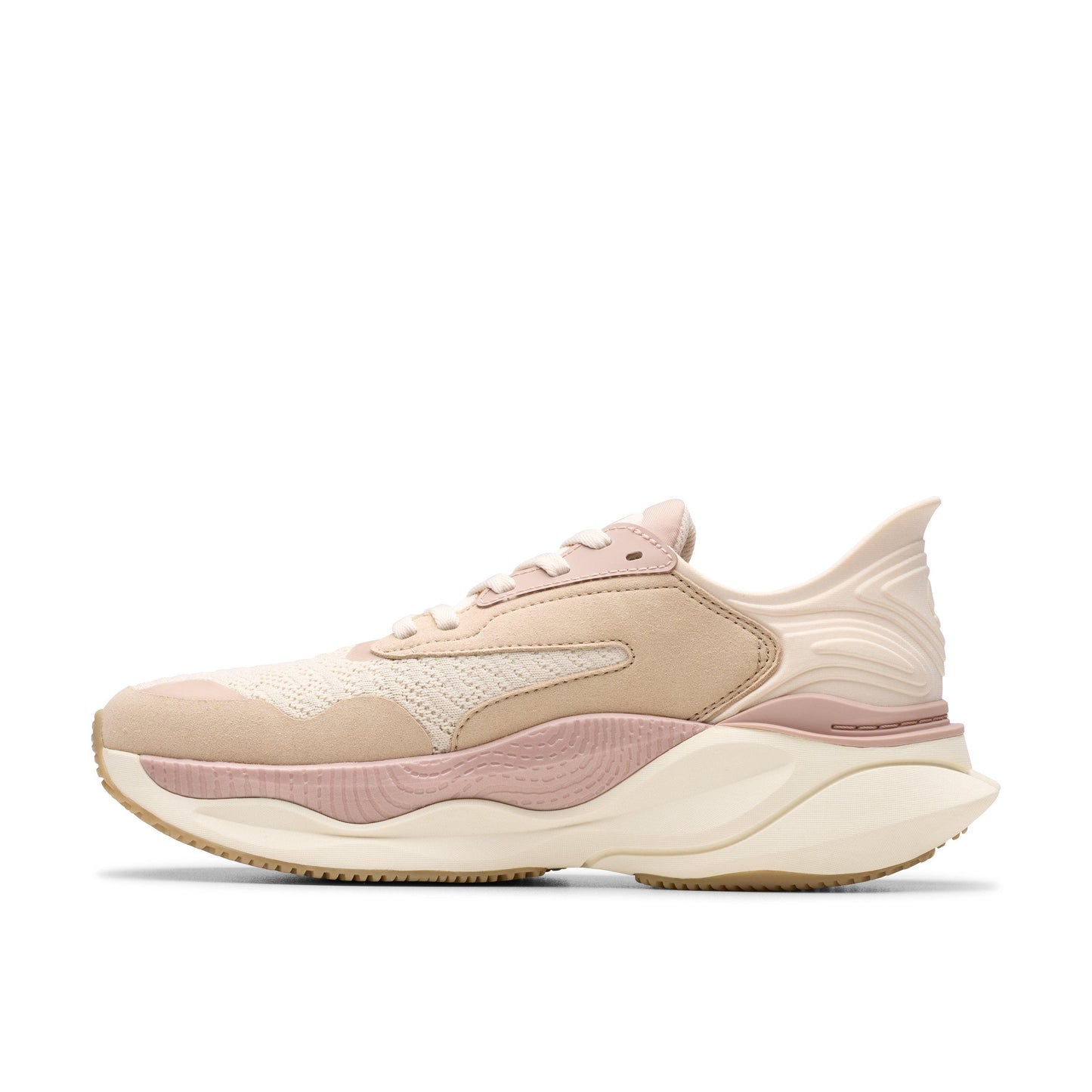 Tan women's sneaker with mesh and textured accents, chunky sole, and wavy heel.