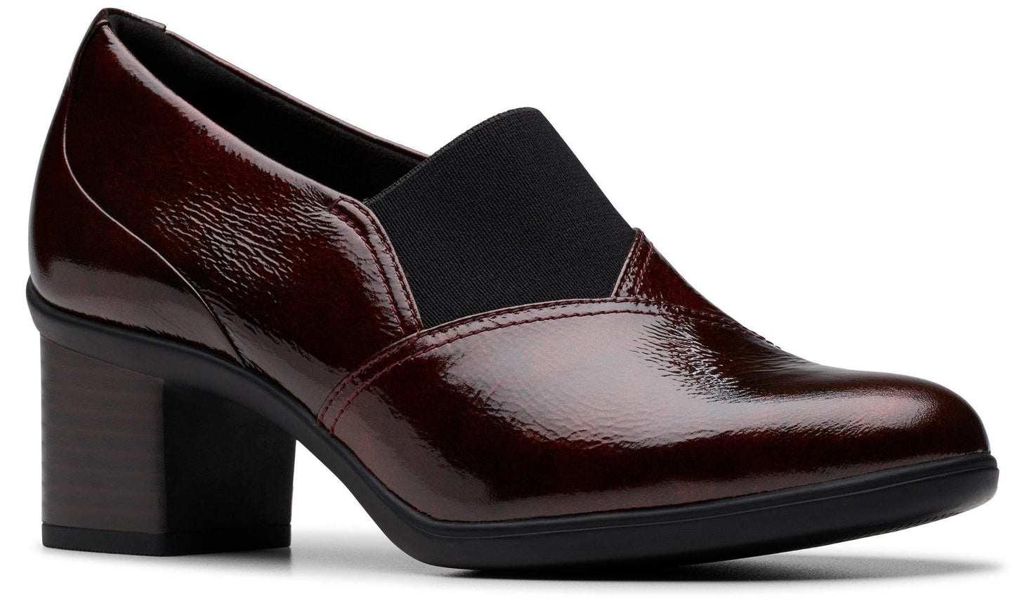 Burgundy patent leather heeled loafer with a block heel and a black elastic panel at the vamp.