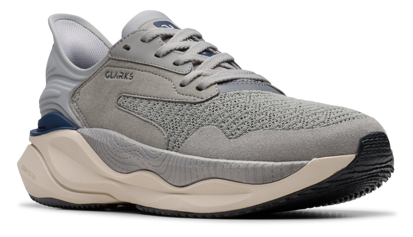 Gray athletic shoe with laces and a thick beige sole, CLARKS text on side.