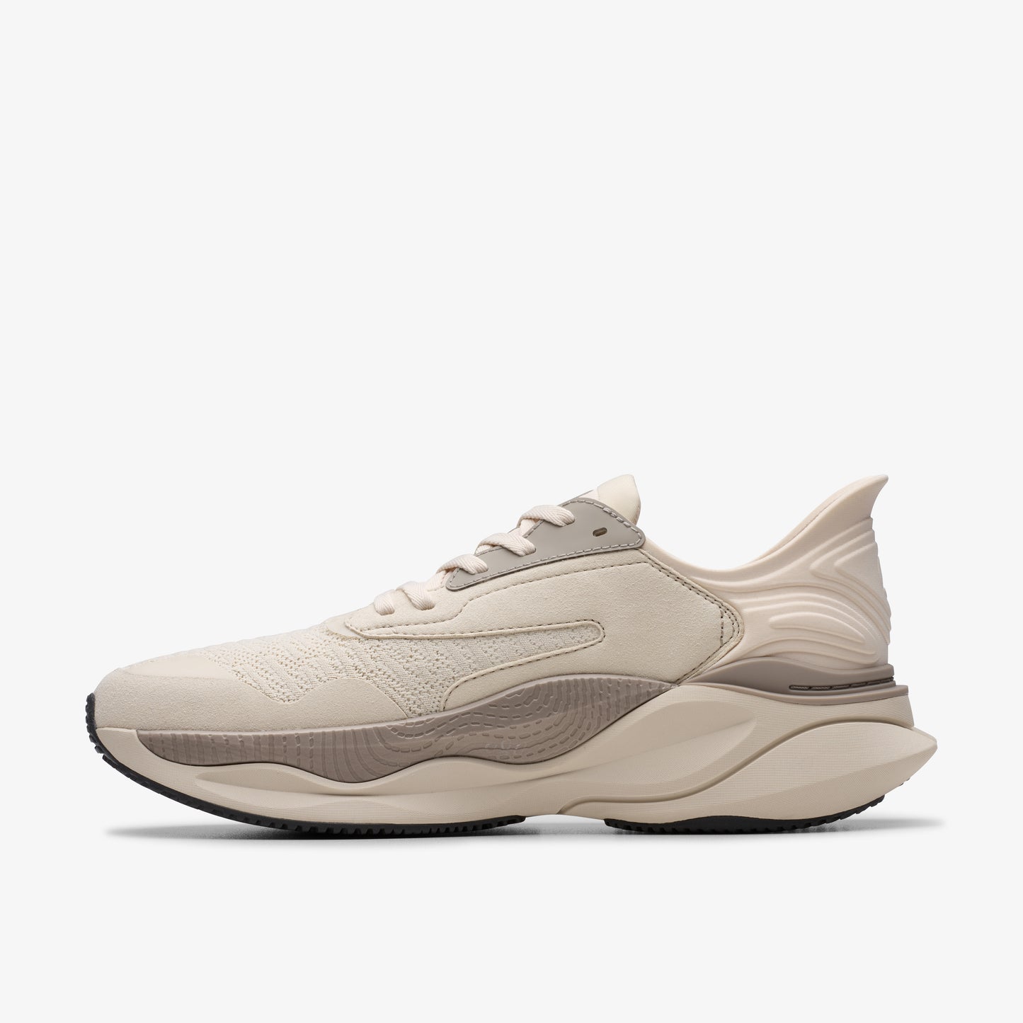 Beige athletic sneaker with a thick sole.
