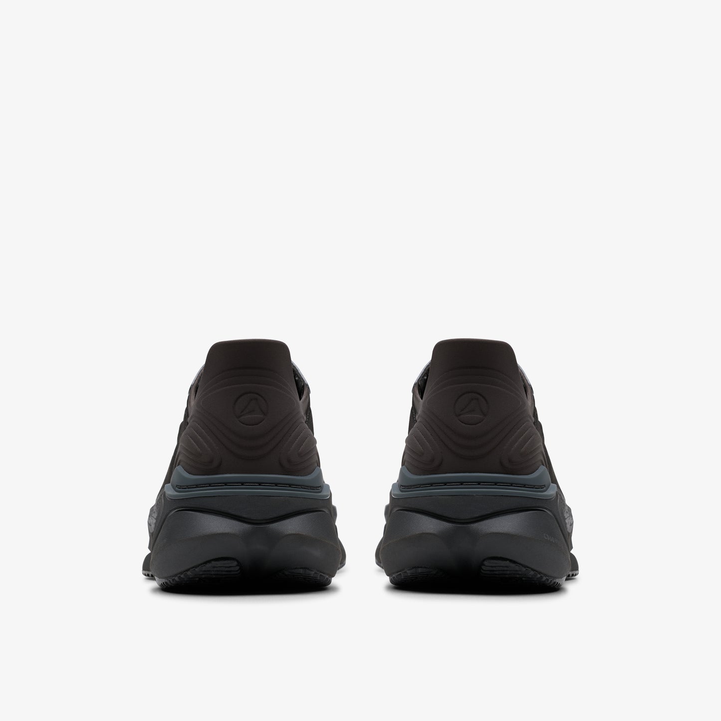 Rear view of a pair of low-profile, dark-colored athletic shoes with sculpted heel and patterned upper.