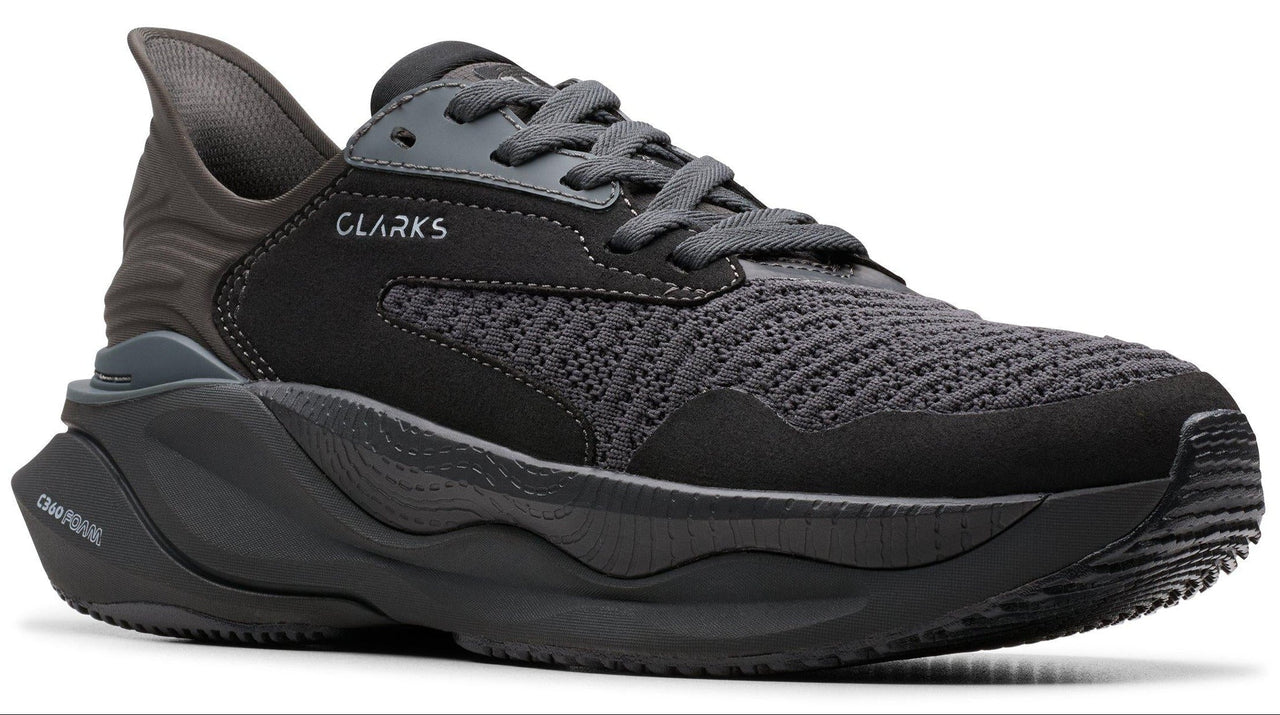 CLARKS running shoe with black mesh upper and thick, sculpted black sole.