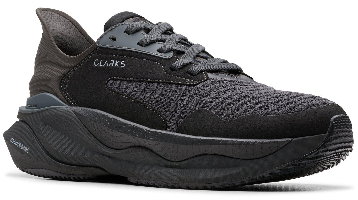 CLARKS running shoe with black mesh upper and thick, sculpted black sole.