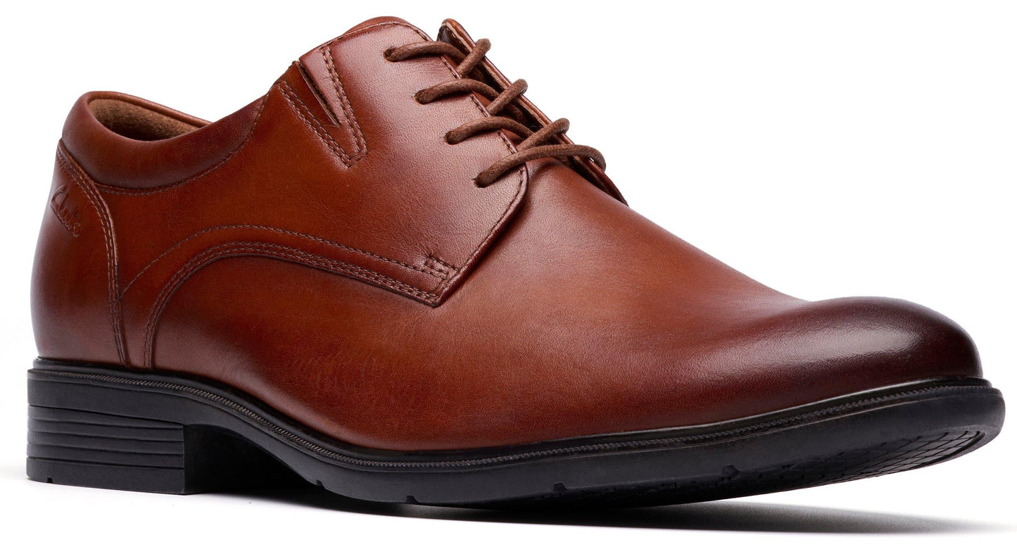 Brown leather dress shoe with laces and a black sole.
