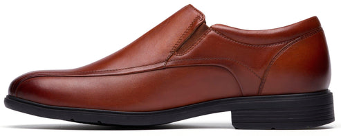 A brown leather slip-on dress shoe with a rounded toe and a black sole.