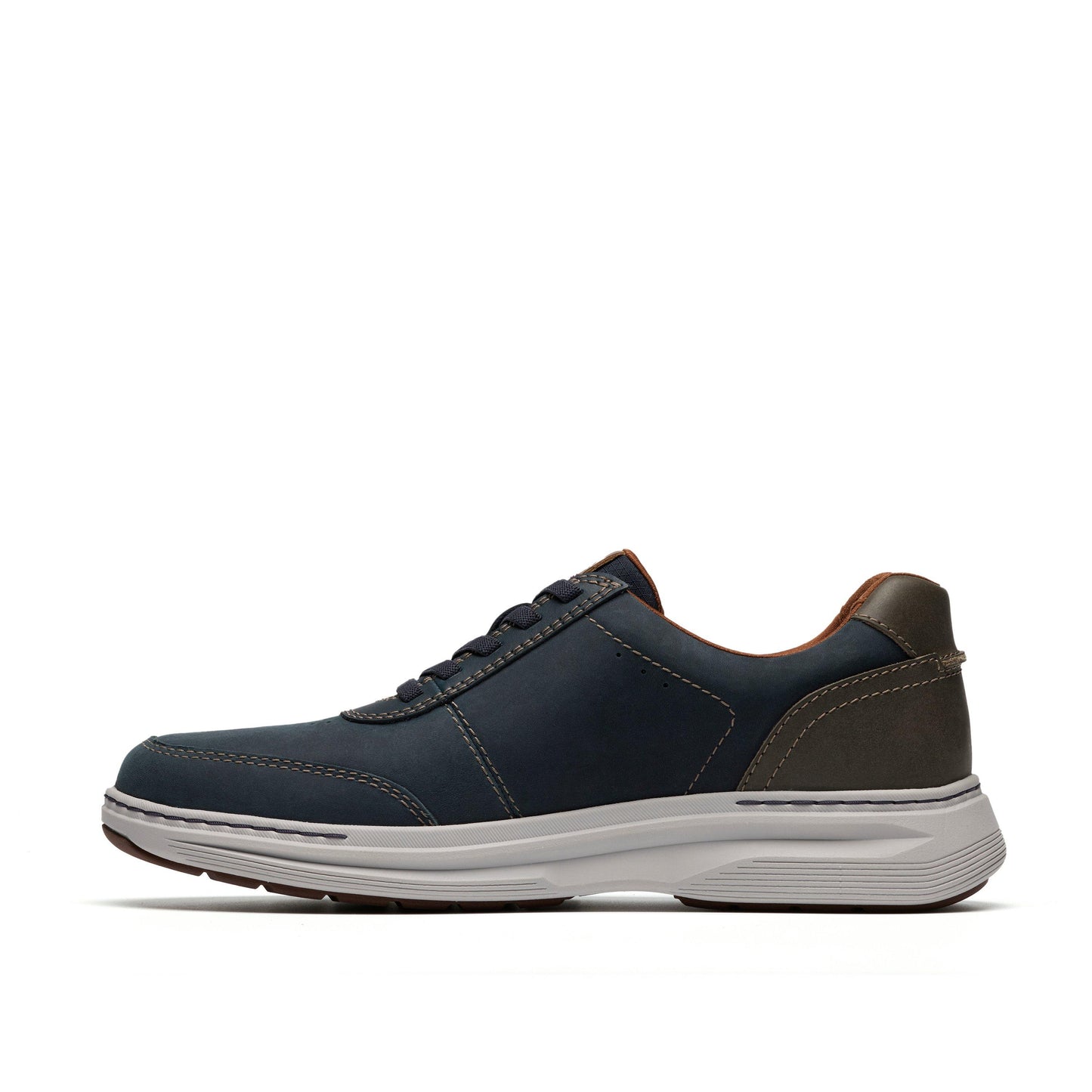 Side view of a navy blue shoe with brown trim and a white sole.