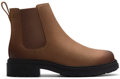 A light brown chelsea boot with a black lug sole and heel.