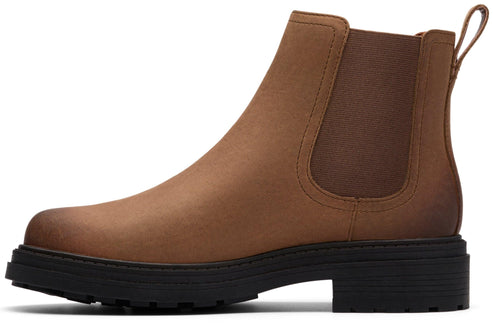 A brown Chelsea boot with a black sole and heel.