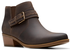 Brown leather ankle boot with buckle strap and low wooden heel.