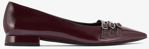 A shiny maroon pointed toe ballet flat with three buckled straps.