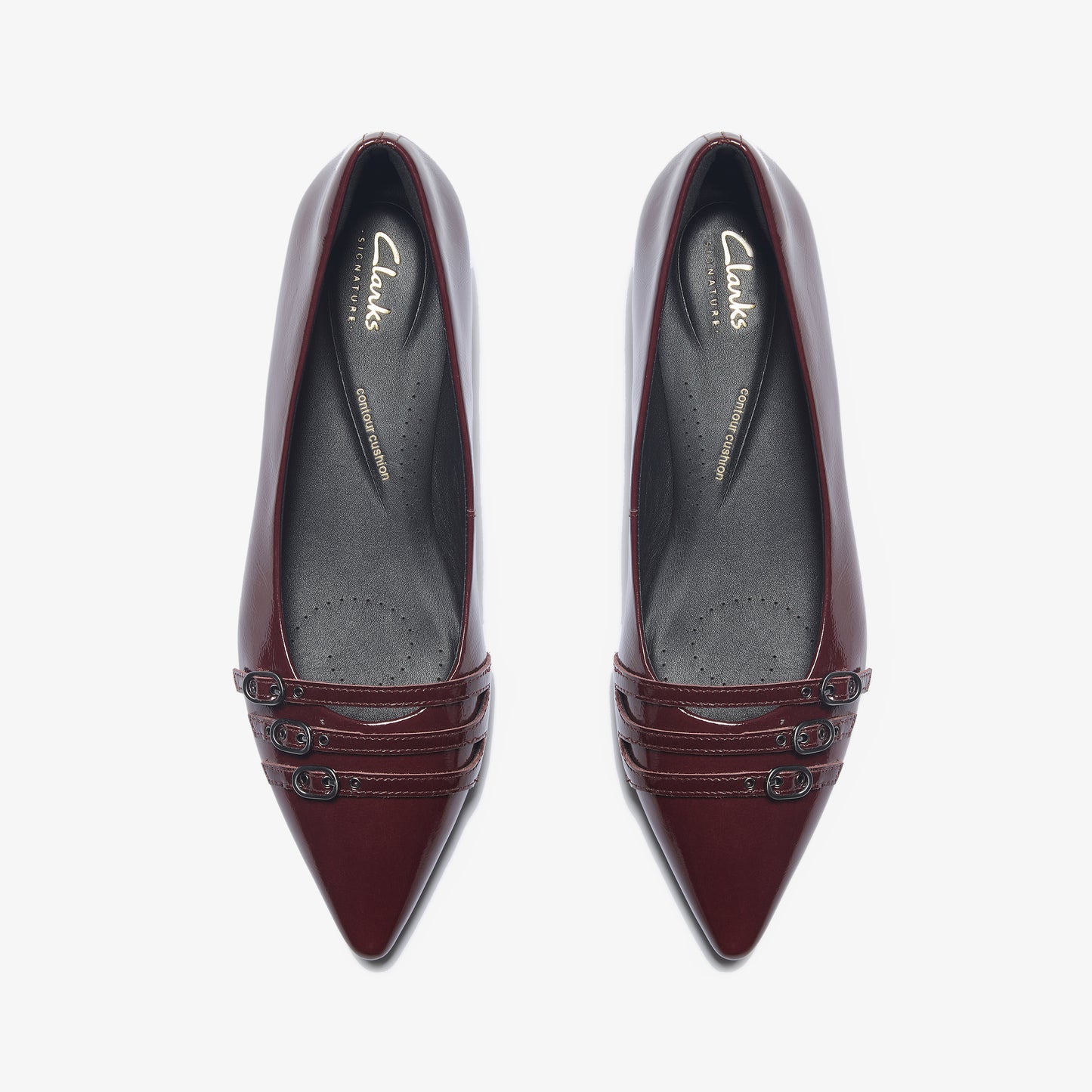 Pair of shiny, wine-colored, pointed-toe dress flats with three horizontal straps at the toe.