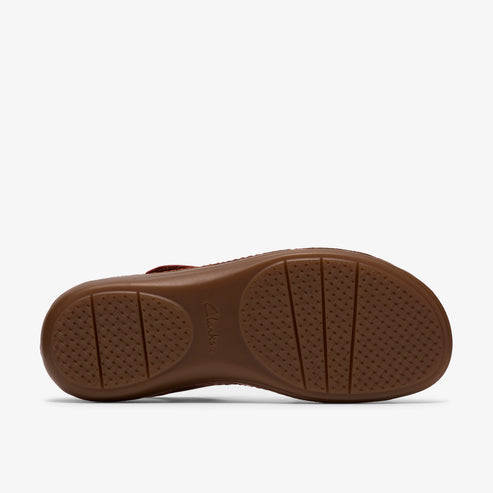 Brown sandal sole with circular and linear tread patterns.