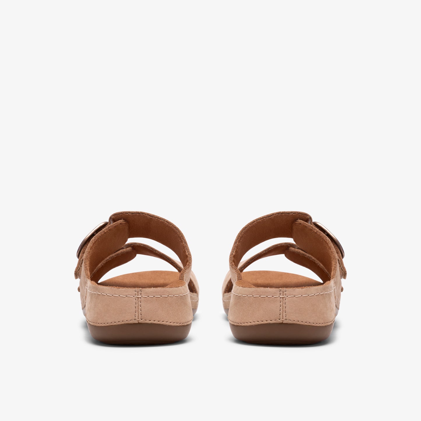 Pair of back-facing brown sandals with adjustable buckle straps.