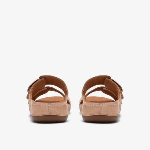 Pair of back-facing brown sandals with adjustable buckle straps.