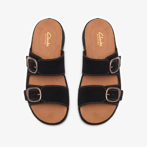 A pair of black, two-strap slide sandals with gold buckles, seen from directly above.
