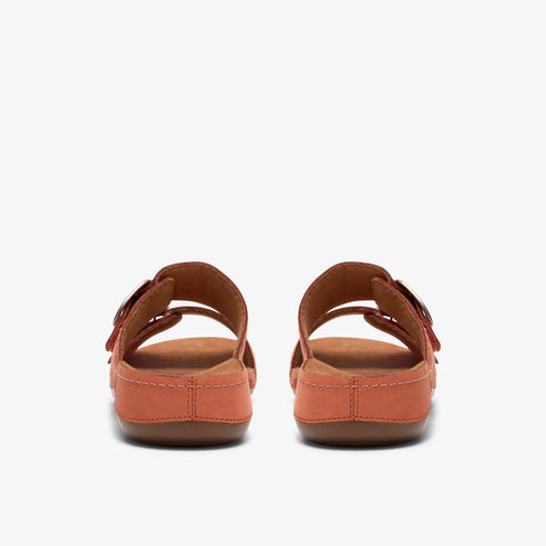 Pair of orange sandals with buckle straps, back view.