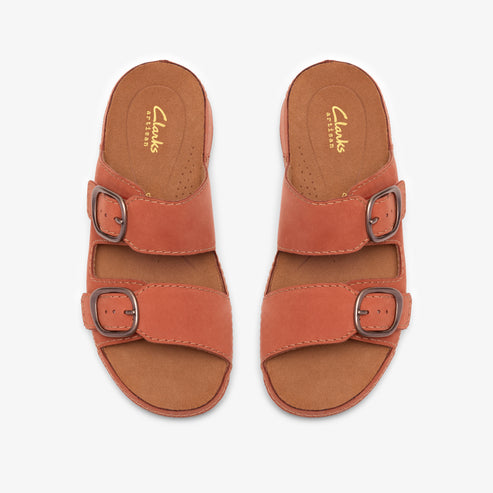 Pair of orange leather sandals with two straps each, each strap featuring a metal buckle. Insole has "Clarks ARTISAN" text.