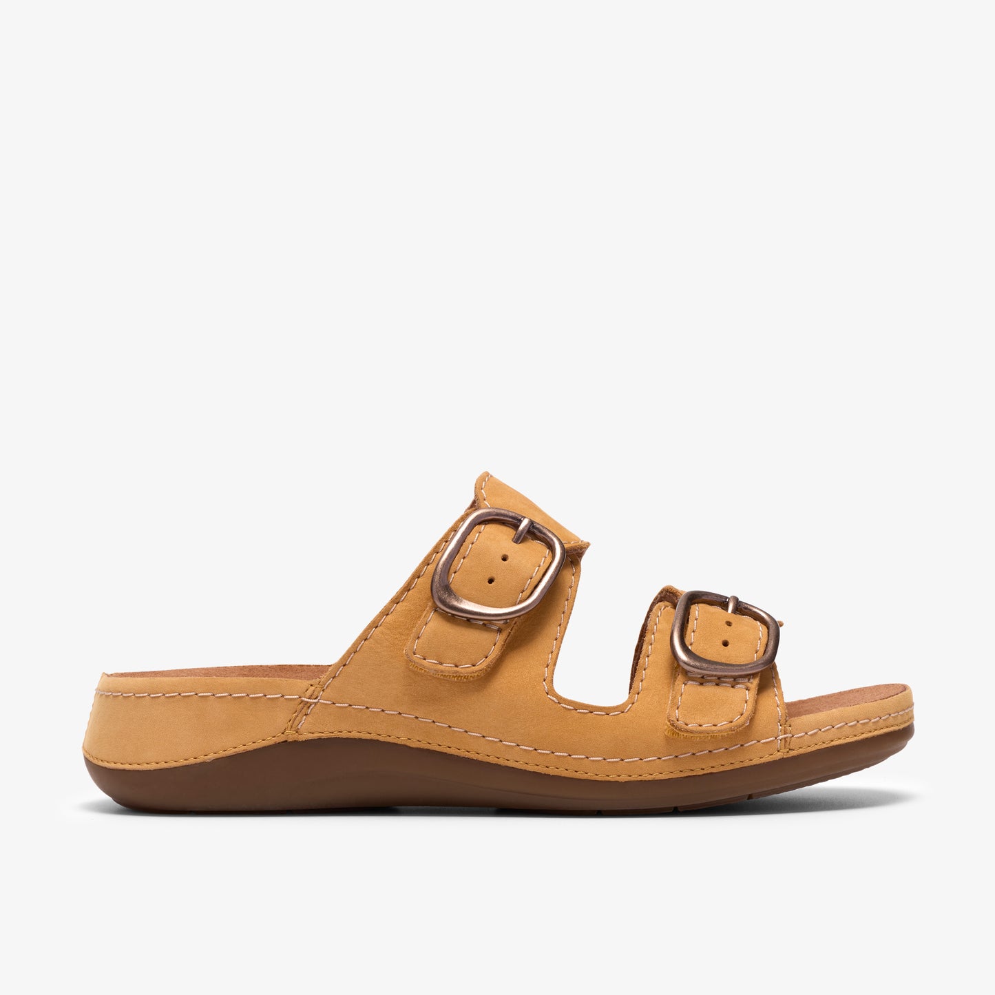 A mustard colored slide sandal with two adjustable straps and silver buckles.