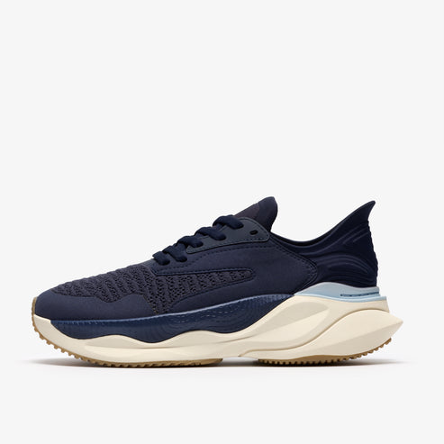 A navy blue running shoe with a light beige sole.