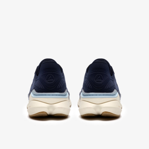 A pair of navy blue athletic shoes with tan soles.