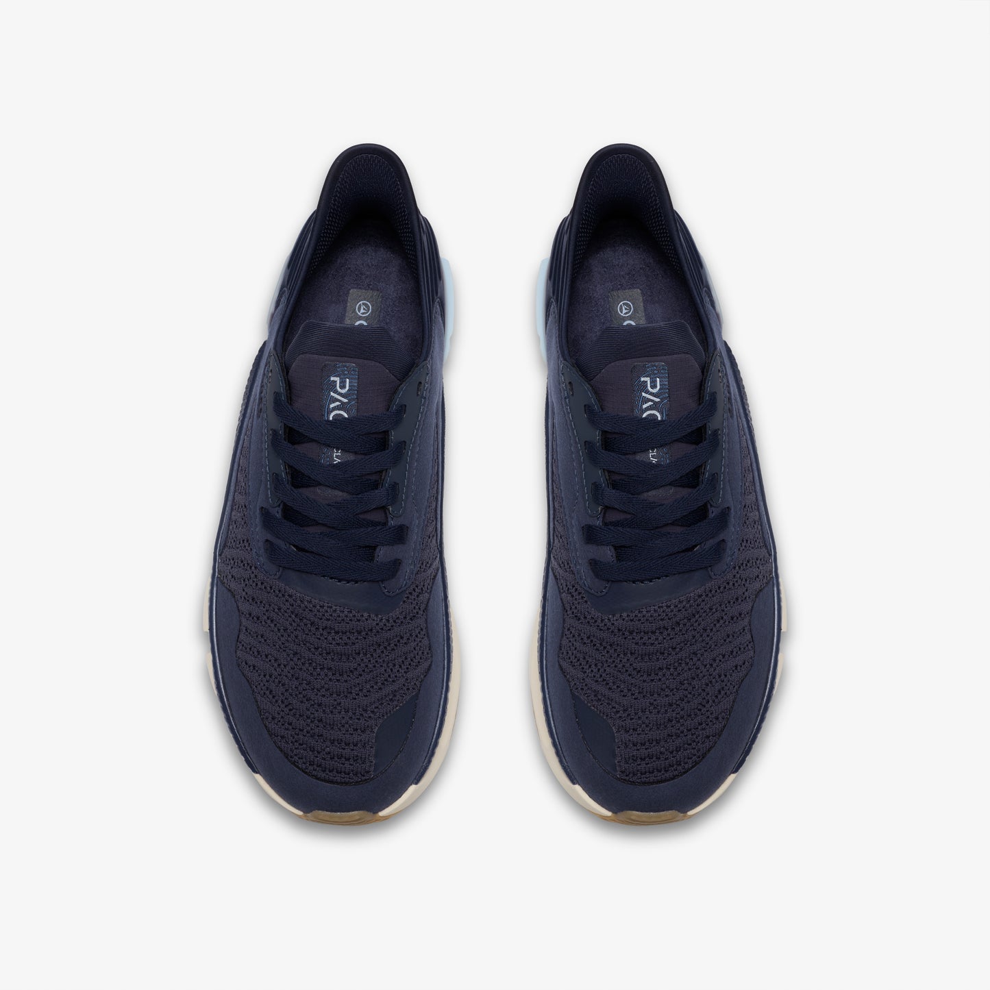 Pair of navy sneakers with laces, viewed from above.