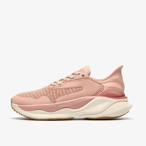 A light pink athletic shoe with a white and tan sole.