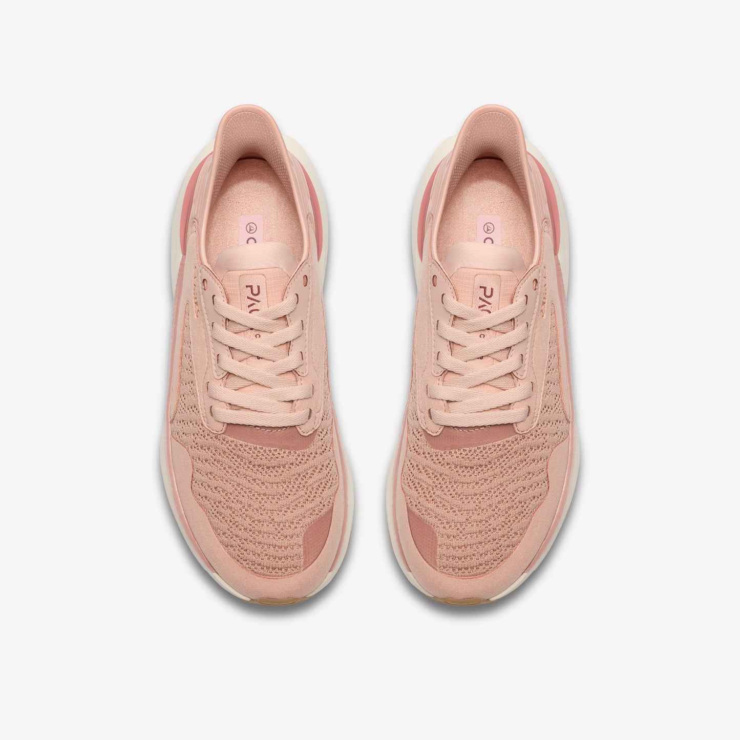 Overhead view of two peach-colored athletic shoes with laces.