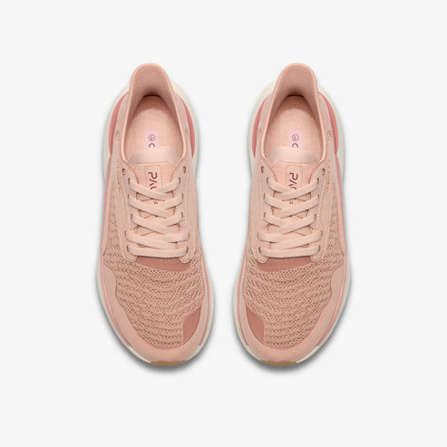 Overhead view of two peach-colored athletic shoes with laces.