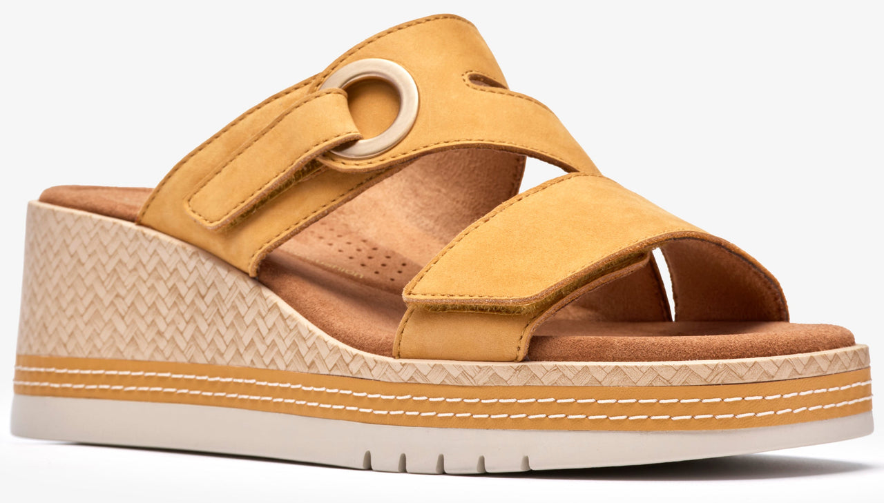 Wedge sandal with yellow straps, one featuring a gold ring.