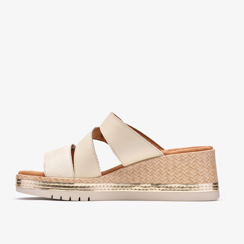 Beige platform sandal with crisscrossing straps.