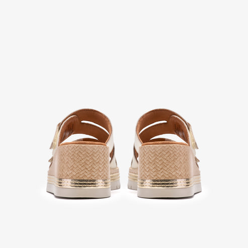Back view of two beige woven slide sandals with gold accents.