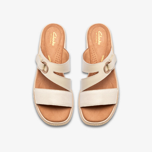 Top-down view of two cream-colored sandals with horizontal and angled straps and gold buckles. "Clarks" printed on insoles.