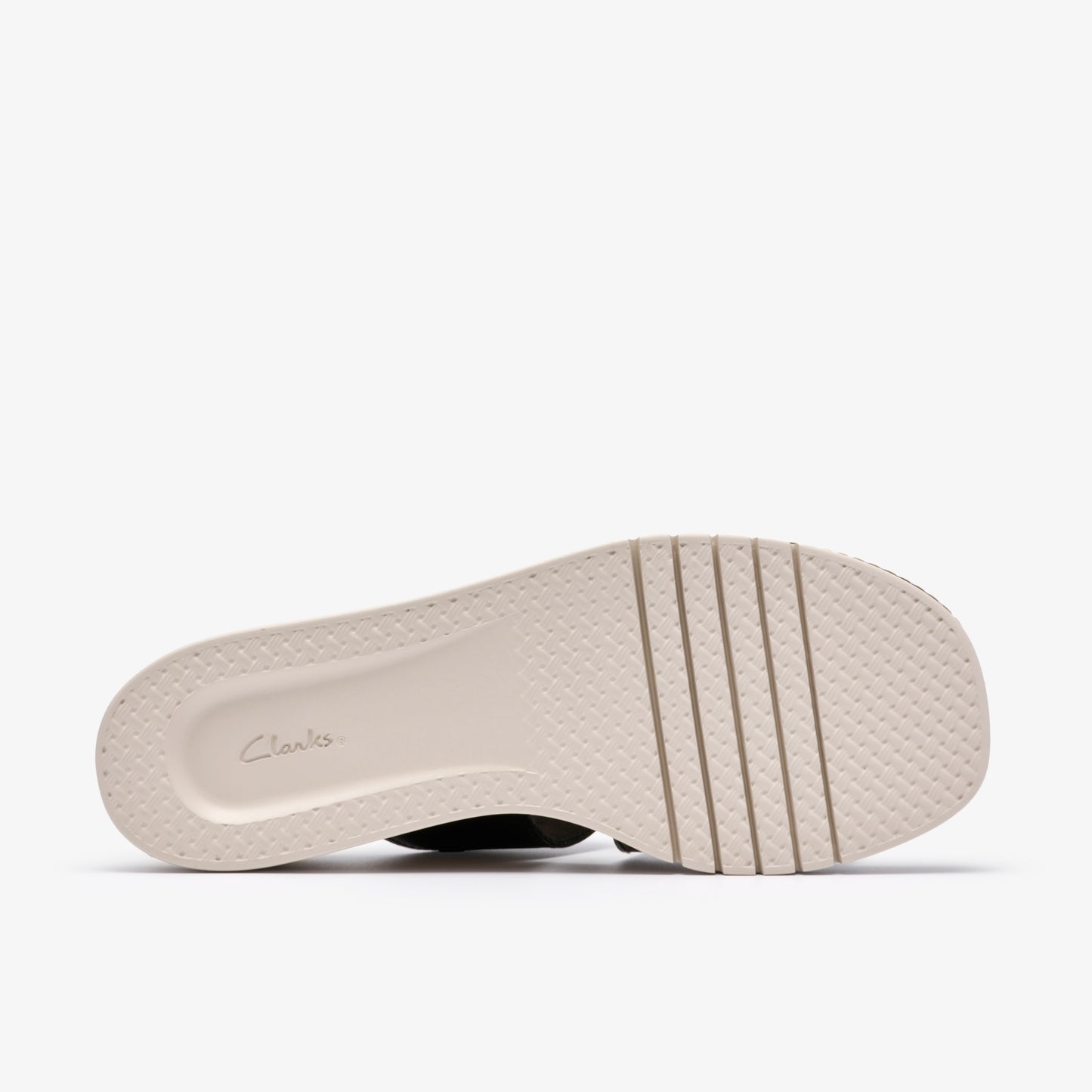 The bottom of a sandal with grooved soles and the text "Clarks" imprinted on the heel.