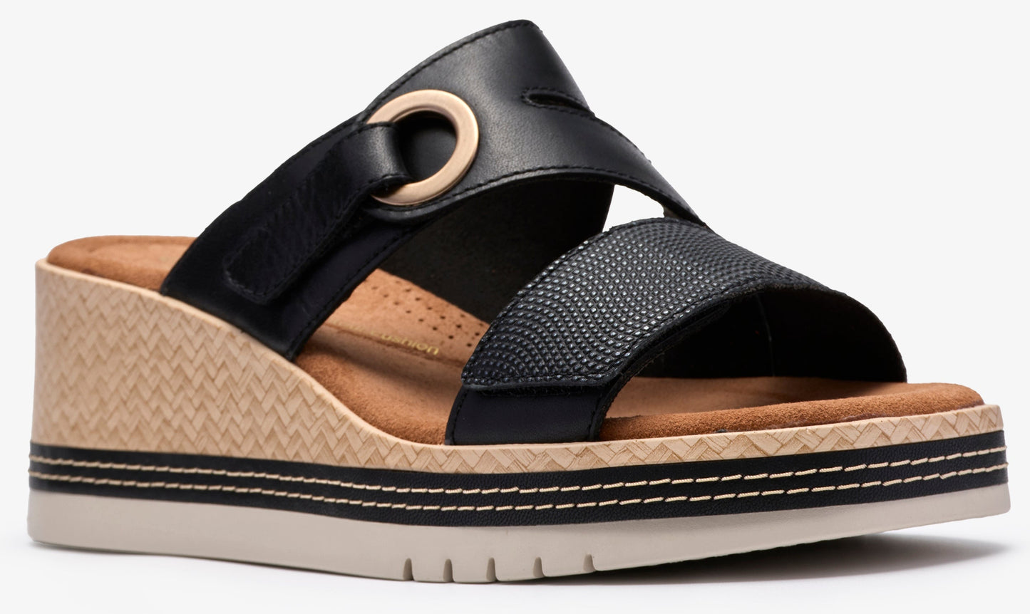 Black sandal with wedge heel, multiple straps, and circular detail.