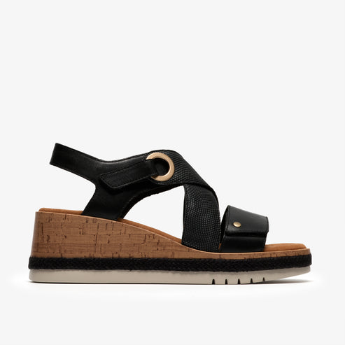 Black wedge sandal with an adjustable ankle strap and a cork footbed.