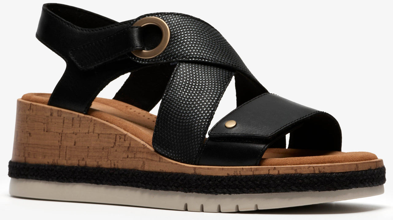 Black wedge sandal with cork platform, black straps and gold hardware.