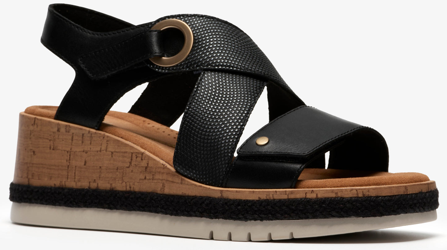 Black wedge sandal with cork platform, black straps and gold hardware.