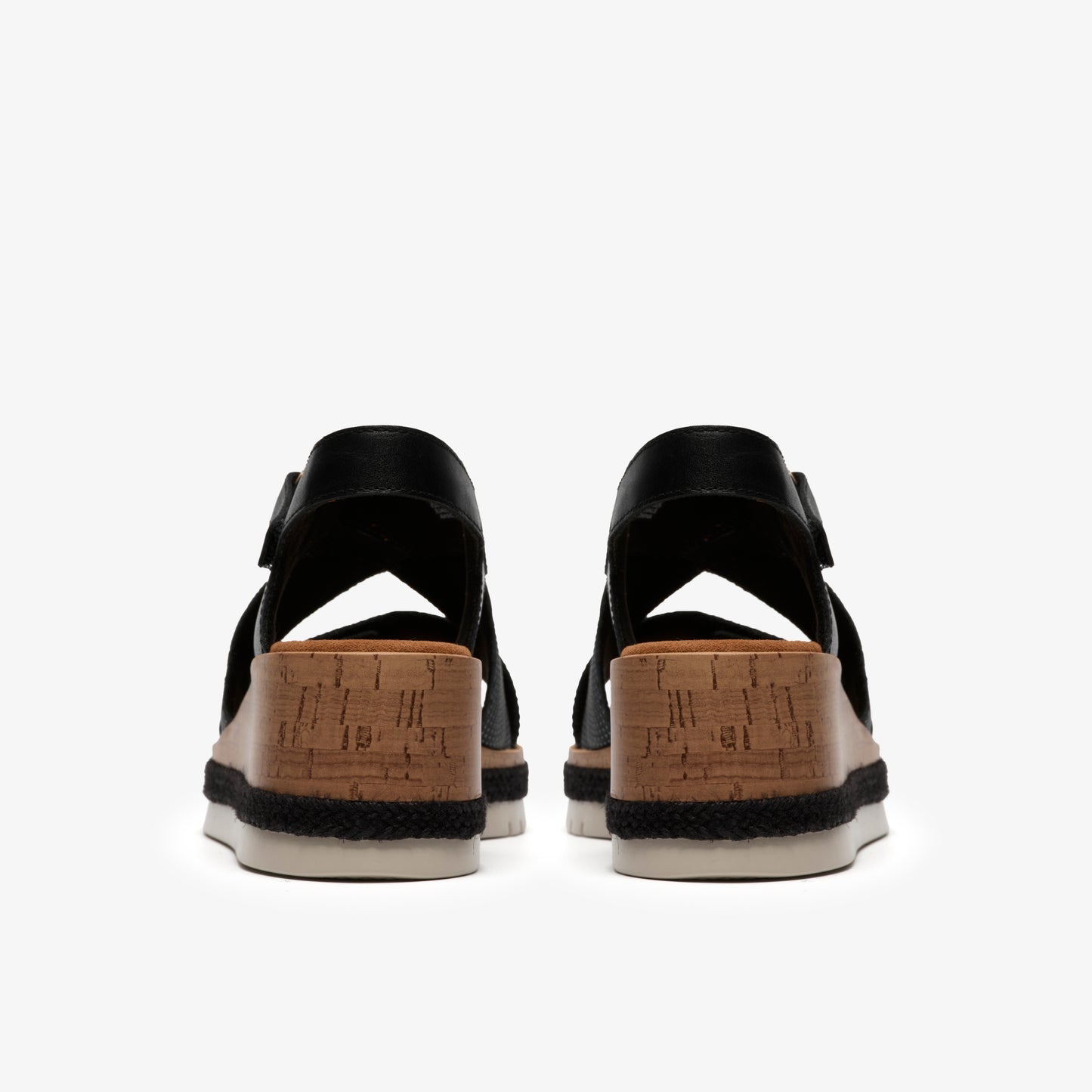 Back view of black wedge sandals with cork platform.