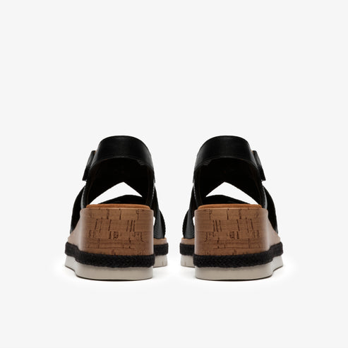 Back view of black wedge sandals with cork platform.