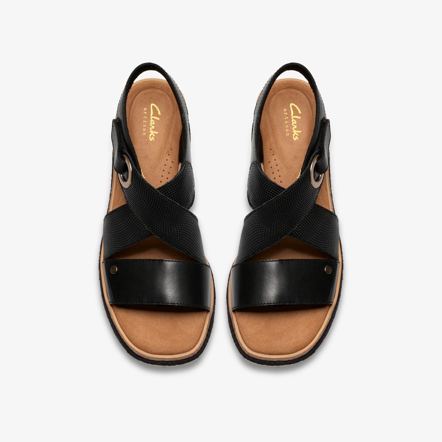 Overhead view of black sandals with criss-cross straps and low heel.
