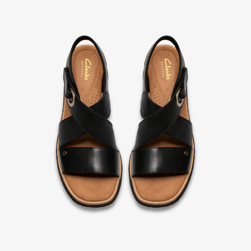 Overhead view of black sandals with criss-cross straps and low heel.