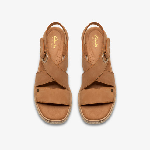 Pair of tan leather sandals with overlapping straps.