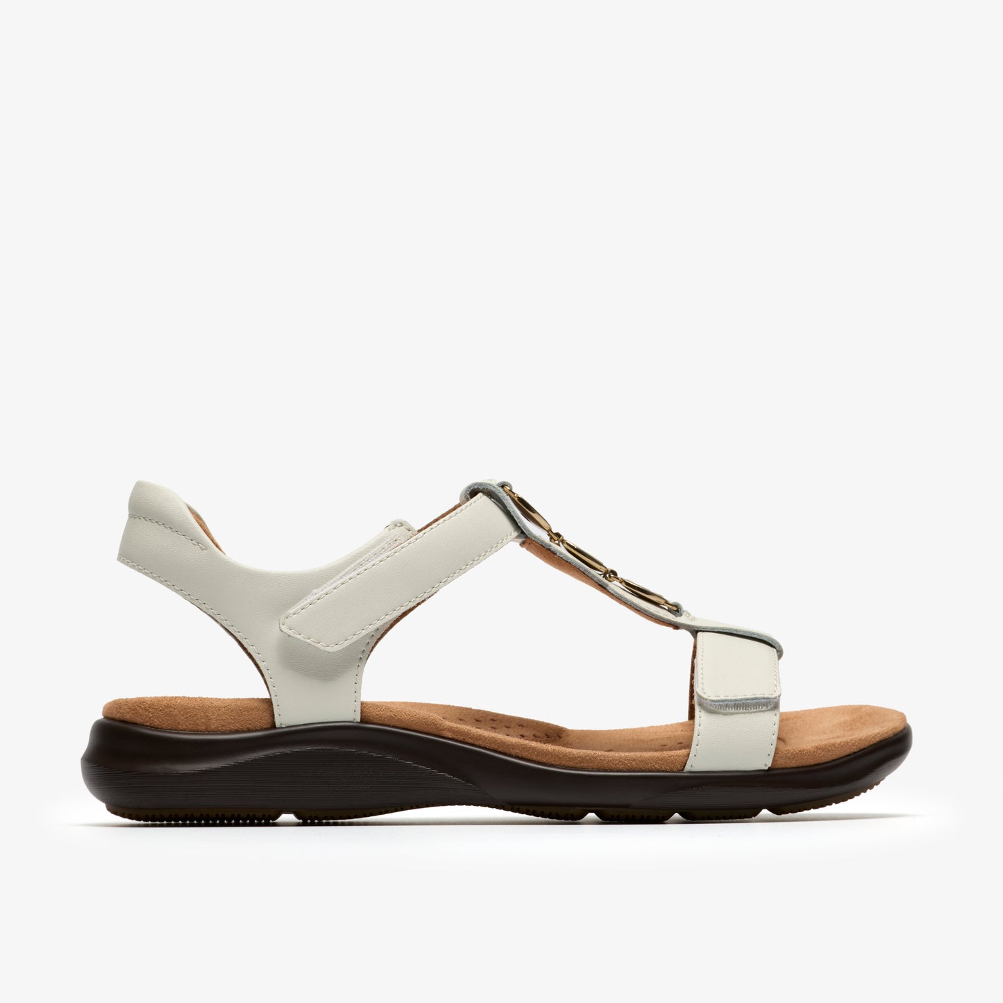 White T-strap sandal with a flat, dark sole and light-brown insole.
