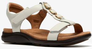 White sandal with t-strap and gold decorative accents, adjustable velcro straps, and a dark sole.