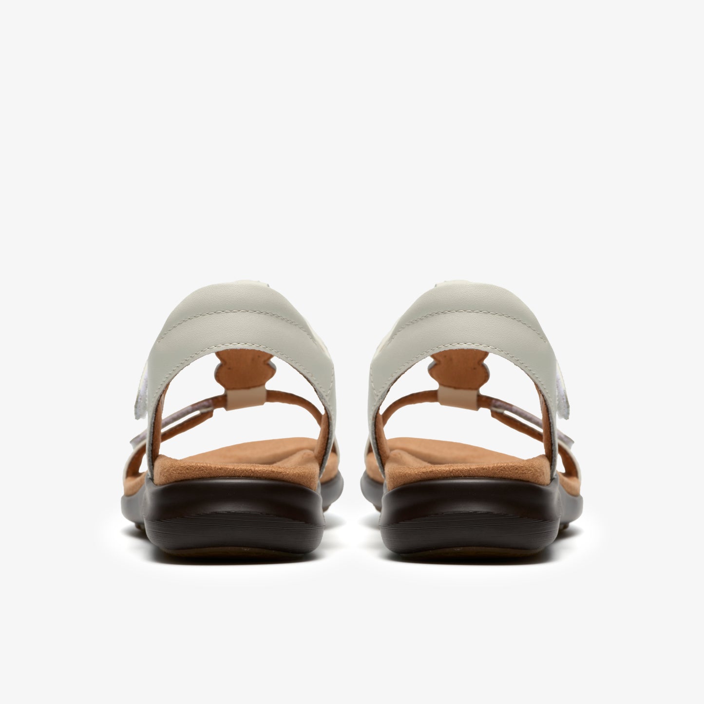 A pair of light gray sandals with a flower pattern, seen from the back.