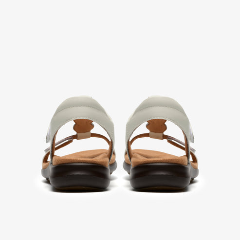 A pair of light gray sandals with a flower pattern, seen from the back.