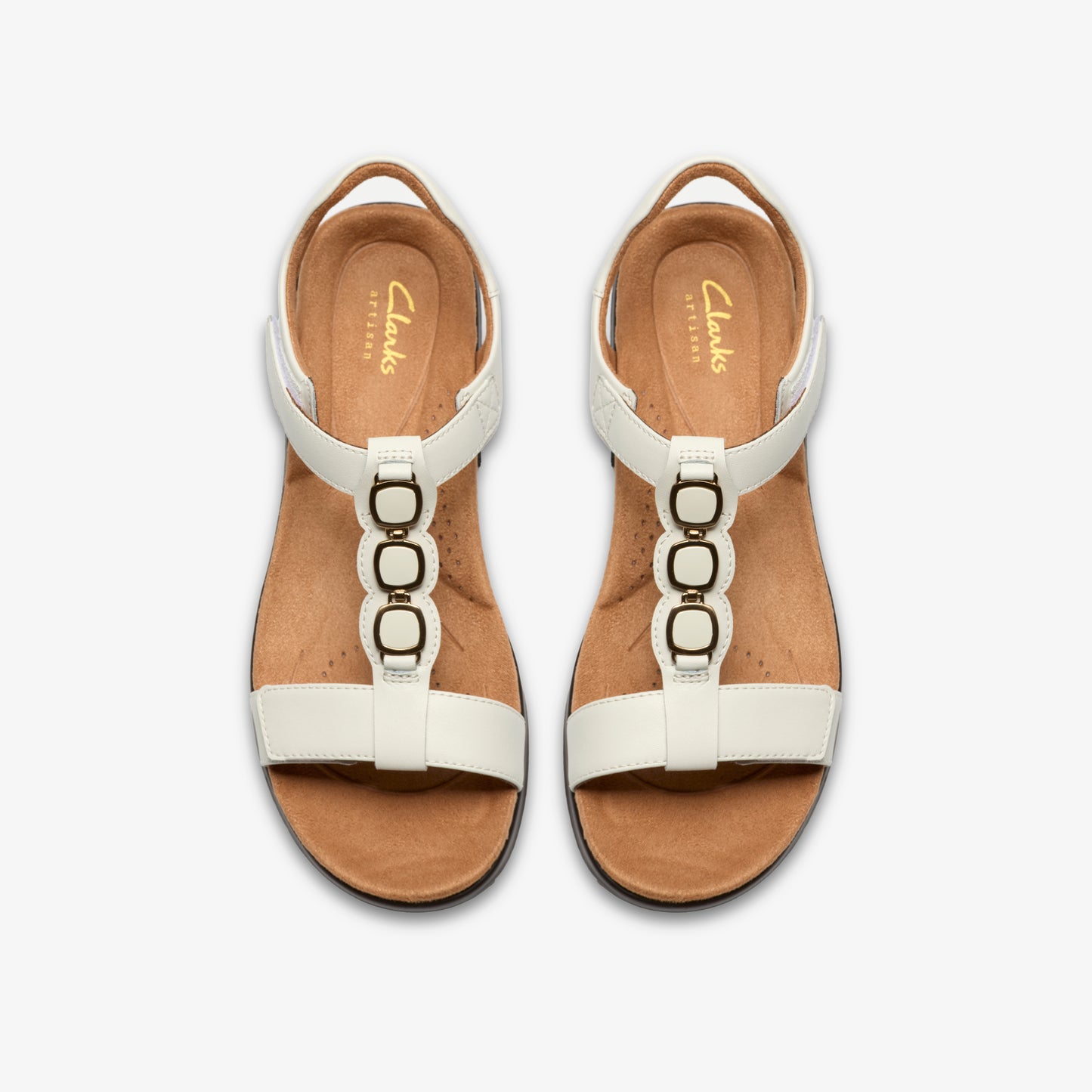 Overhead shot of white sandal shoes with three linked circles.